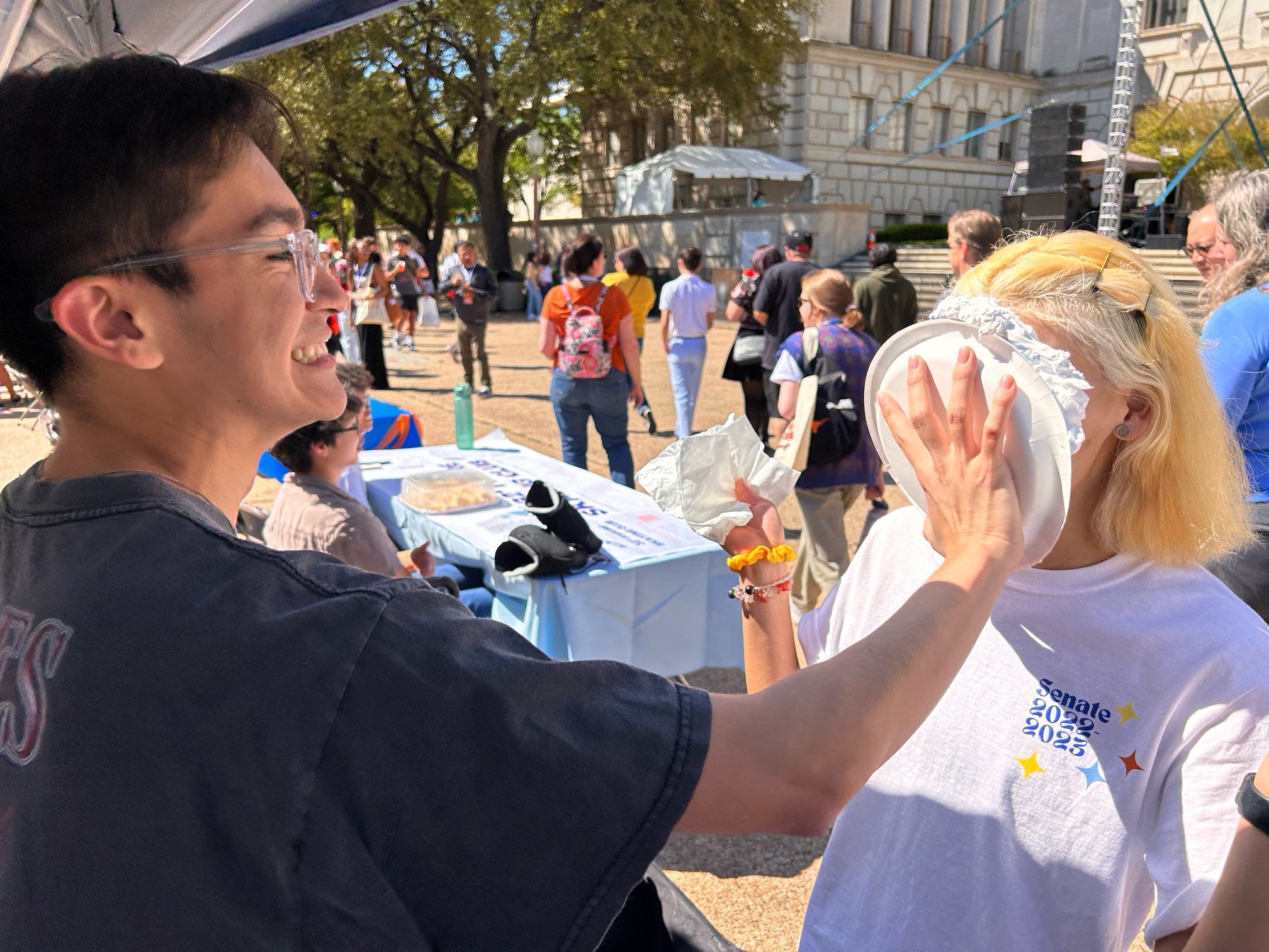 SCC Member placing whipped cream on another SCC member's face. 
